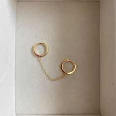 Two small huggie hoops connected by a delicate chain. SOLD AS A SINGLE PIECE Chain Earring, Ball Bracelet, Sell Gold, Delicate Chain, Gold Hoops, Chain Earrings, Pretty Jewellery, Cz Stone, How To Style