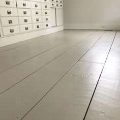 an empty room with many drawers and white walls