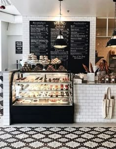 the inside of a bakery with lots of pastries on display