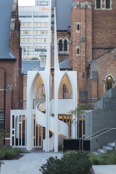 a large white building with a spiral staircase leading up to it