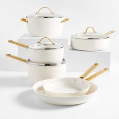 white pots and pans with gold handles