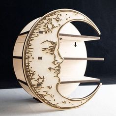 a wooden clock that is shaped like the moon