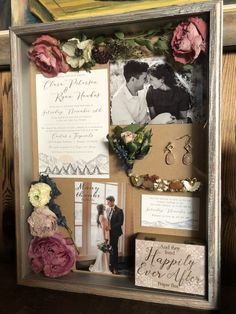 a wooden frame with pictures and flowers on the inside is decorated with cards, photos, and other items