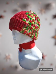 Crocheted hat with a flip brim. Multi-color, mostly red. Bells attached to top. Superwash Merino wool. Warm and stretchy. Adjustable Brimmed Red Crochet Hat, Red Beanie Hat, One Size Fits Most, Red Crochet Hat With Adjustable Short Brim, Red Brimmed Crochet Hat, Red Beanie Hat One Size Fits Most, Red Brimmed Winter Hat, Red Winter Bonnet (one Size Fits Most), Red Winter Bonnet, One Size Fits Most, Red Bonnet For Winter, One Size Fits Most