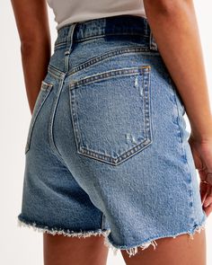 High rise with a relaxed fit throughout the hip and thigh, and a 5 inch (13 cm) inseam. Vintage stretch denim in a medium wash, with frayed hem. Women's Bottoms, Medium Size, Abercrombie Fitch, Stretch Denim, High Rise, Relaxed Fit