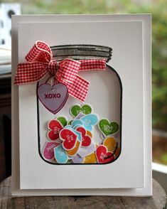 a card with hearts in a mason jar