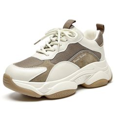 a woman's white and brown sneaker with laces on the side,