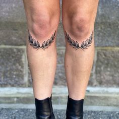 a woman's legs with tattoos on them