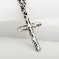 Our Ripples Cross pendant necklace is perfect for expressing your faith in a stylish way. This sterling silver necklace is handmade for a sturdy and solid feel, and its unique design captures the gentle ripples and soft curves of water. It's ideal as a special gift to a loved one or as a symbol of faith. What better way to celebrate a First Communion or Confirmation? Silver Spiritual Cross Necklace With Adjustable Chain, Spiritual Stainless Steel Cross Pendant Necklaces, Spiritual Silver Cross Necklace With Adjustable Chain, Spiritual Necklace With Silver Chain And Cross Pendant, Spiritual Silver Chain Necklace With Cross Pendant, Handmade Stainless Steel Cross Pendant Necklace, Spiritual Crucifix Necklace With Silver Chain, Handmade Stainless Steel Cross Necklace, Hammered Cross Pendant Necklace For Gift