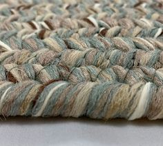 a close up view of some yarn on a white table cloth with brown and blue stripes