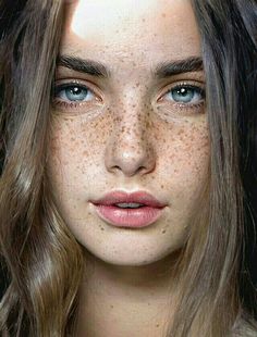 a woman with freckled hair and blue eyes