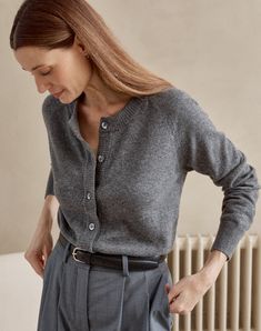 We've taken our best-selling WEEKEND jumper and created a cardigan companion. The same raglan sleeve, the same fine-knit gauge and same the double folded neck trim that extends down the placket. Made from 100% superfine, traceable Italian-spun Merino wool. Finished with five of our signature Mother of Pearl buttons. To wear alone, or layered over a favourite t shirt, in that all-time favourite Atlantic Grey shade. All Grey Winter Outfit, Dark Grey Knit Sweater Outfit, How To Style Grey Sweater, Little Cardigan Outfit, Button Down Cardigan Outfit, Fitted Cardigan Outfit, Grey Shirt Outfit, Grey Cardigan Outfit, Gray Shirt Outfit