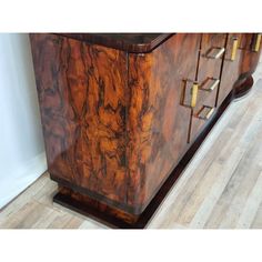 an antique sideboard with brass handles and wood grained finish on the top, in good condition