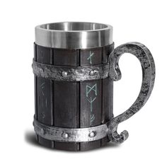 a wooden mug with metal handles and designs on it