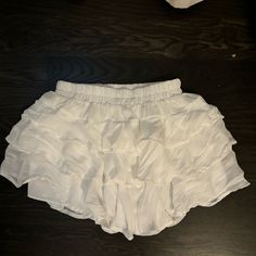 Super Cute Flowy Skirt! Still Has Its Tags On!!! Flowy Short Skirt With Ruffles, White Ruffled Short Mini Skirt, Flowy Ruffled Short Skort, White Tiered Ruffled Skort, White Skirted Shorts With Ruffles, Vacation Ruffled Skirt Shorts, Summer Party Skort With Elastic Waistband, White Ruffled Skirt Shorts For Day Out, Vacation Skirt Shorts With Ruffles