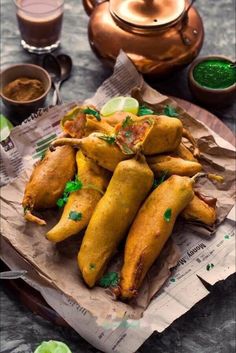 some food that is sitting on top of a piece of paper with sauce in the background