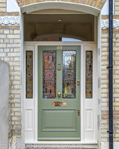 a green front door with stained glass panels