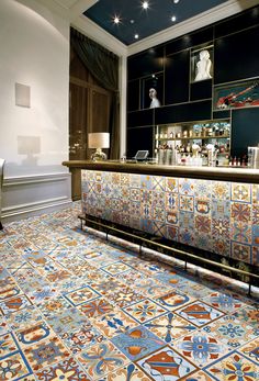 the bar is decorated with colorful tiles in an elegant style and looks like it could be used as a restaurant