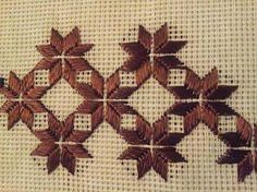 an embroidered piece of cloth with leaves on it