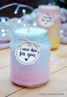 two candles sitting on top of a wooden table next to each other with labels that say i made this for you