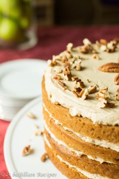 a cake with frosting and pecans on top