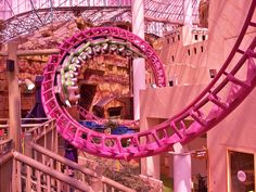 the roller coaster is pink and purple in color