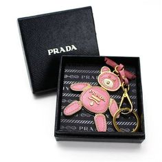 Auth PRADA Saffiano Bag Charm Bear Key Chains PETALO Pink Leather, Metal Description Condition: B (Good condition but signs of small scratches and / or stains) Accessory: Box Color PETALO Pink Size (approx): Length 18cm W 7.5cm Size (approx ): Length 7.09inch W 2.96 inch Condition: B  N : (New)  S : (Almost brand new)  A : (Great condition Light signs of use with tiny scratches and/or stains)   B : (Good condition but signs of small scratches and/or stains)  C : (Noticeable signs of use with scr Gold Bags With Branded Hardware For Gifts, Luxury Bags With Logo Charm For Gift, Designer Gold Bag With Logo Charm, Designer Gold Bags With Logo Charm, Luxury Jewelry Gift With Metal Logo, Luxury Jewelry With Metal Logo For Gift, Prada Saffiano Bag, Prada Bag Saffiano, Bear Signs