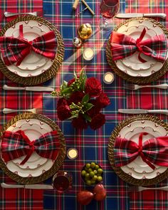 the table is set with red and white plates