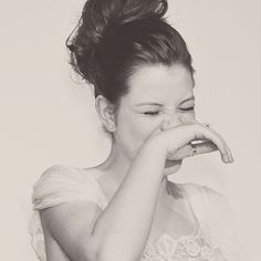 a black and white photo of a woman covering her mouth