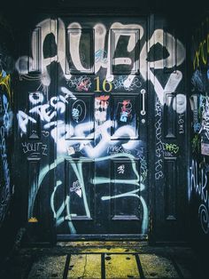 the door is covered in graffiti and spray paint