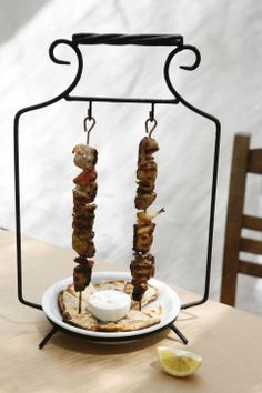 two skewered meats are on a plate