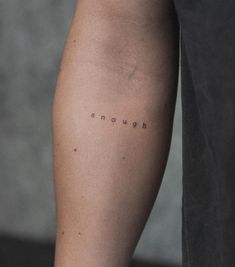 a woman's leg with the word enough written on it