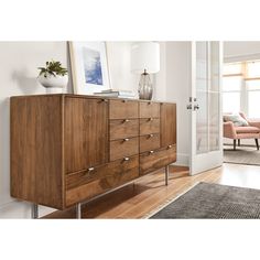 a large wooden dresser sitting on top of a hard wood floor next to a door