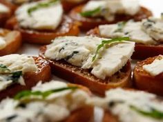 several pieces of bread topped with cheese and herbs