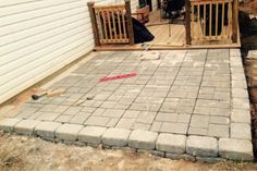 a brick patio being built in front of a house