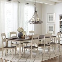 a dining room table with chairs and a chandelier