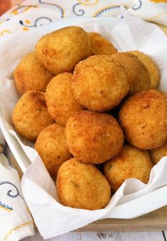 some fried food in a white bowl on a table