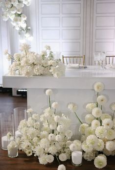 white flowers and candles are on the table