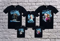 three shirts with frozen princesses on them against a brick wall, one is black and the other is blue