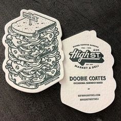 a close up of a business card with a sandwich design on the front and back