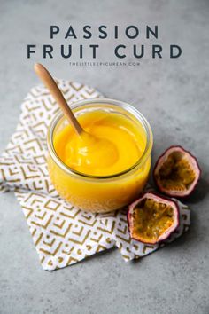 passion fruit curd in a small glass jar with a wooden spoon next to it