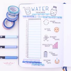 an open planner with water tracker on it next to some washi tapes and markers