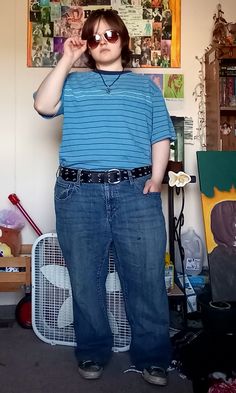 mid sized teen with sunglasses in a blue shirt with thin white and brown parallel stripes, blue jeans, black and metal circle belt, and converse shoes, not featured in the photo, but wearing orange black and blue garfield socks. Masc Girl, Androgynous Outfits, 1980's Fashion, Hipster Grunge, 90's Grunge, 1990's Fashion, Girl Falling