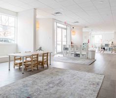 an empty room with tables and chairs in it