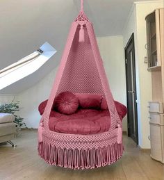 a pink hammock hanging from the ceiling