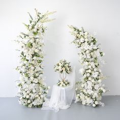 two white flowers are arranged in the shape of an arch