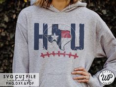 a woman wearing a gray hoodie with the word h u in red, white and blue