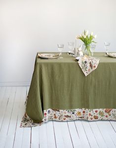 a green table cloth with flowers on it