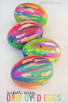 four easter eggs with colorful paint on them and the words super easy drip dyed eggs