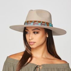 Beige rancher hat with a leather band. The leather band has turquoise color accents.